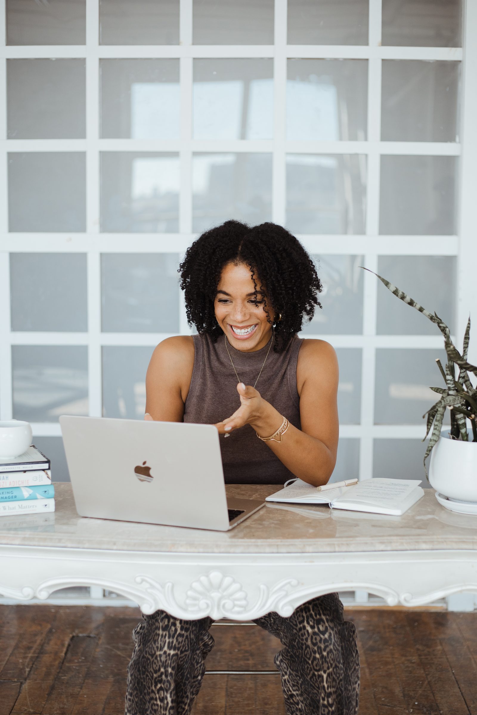 Leya laughing at her desk