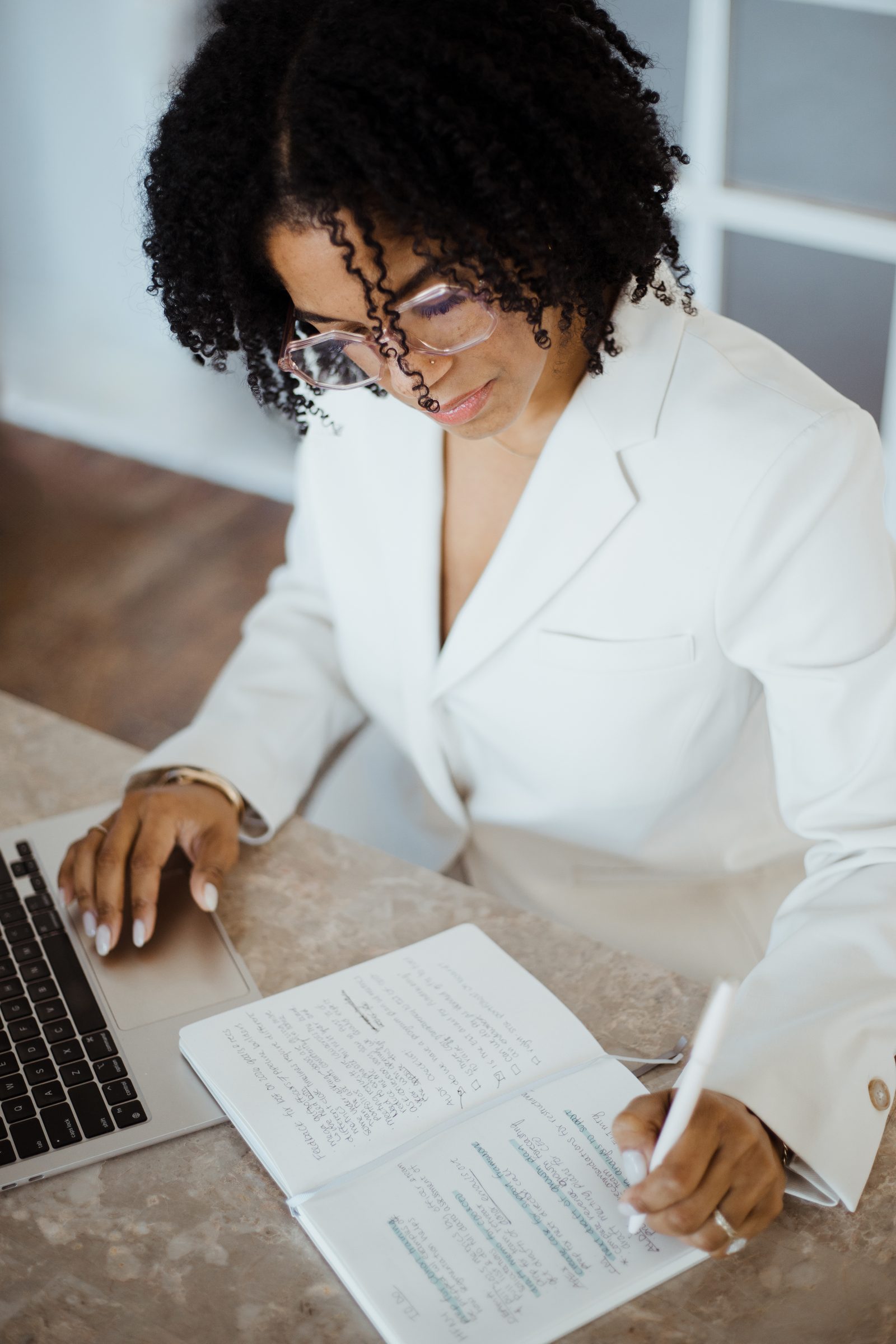Leya writing strategy notes while working at her desk